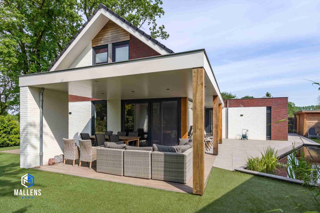 De veranda met een loungebank en een grote eettafel voor 6 personen.